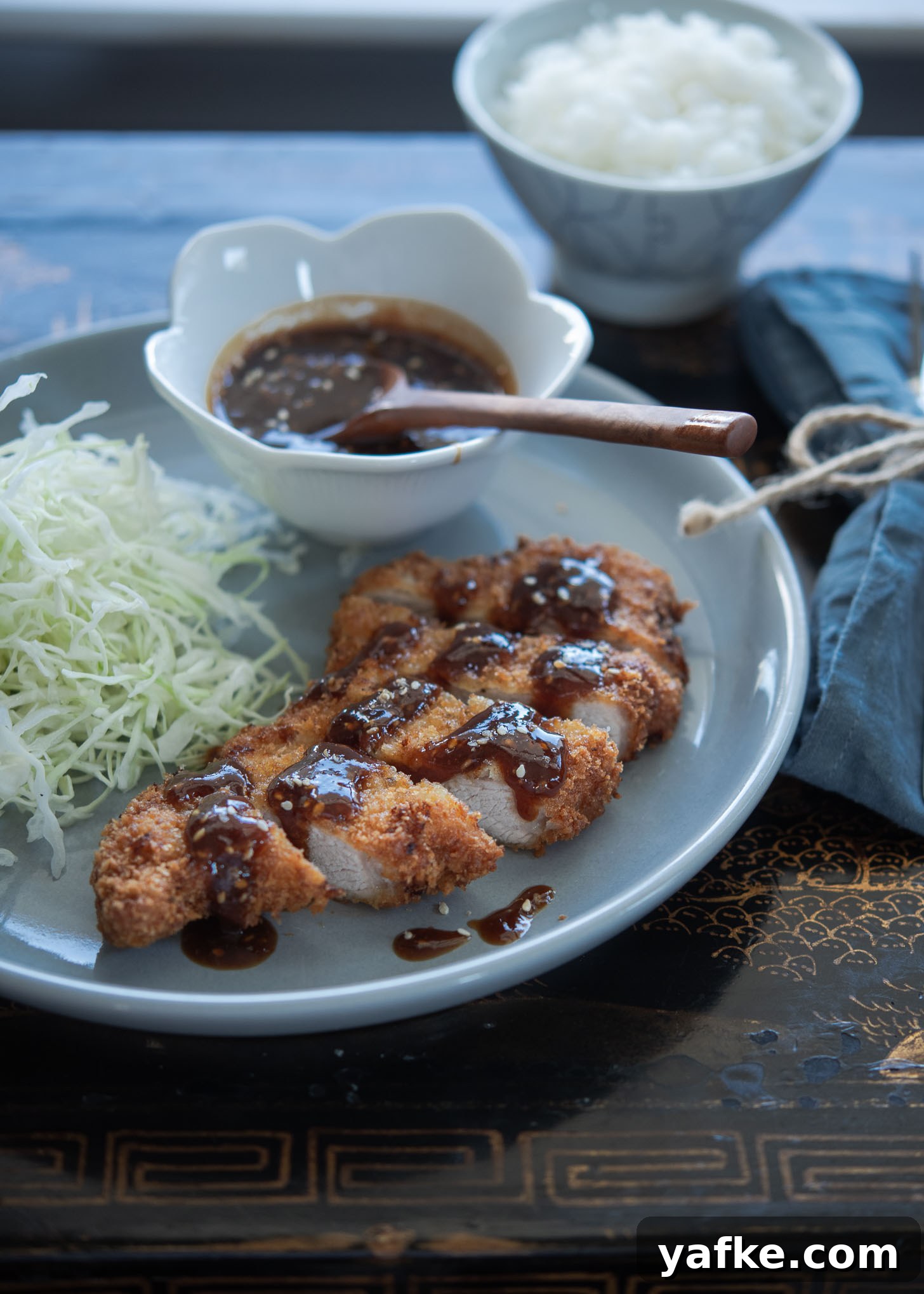 How to Make Crispy Japanese Tonkatsu in 30 Minutes 3 Tonkatsu (Japanese-style fried pork cutlet) paired with cabbage salad.