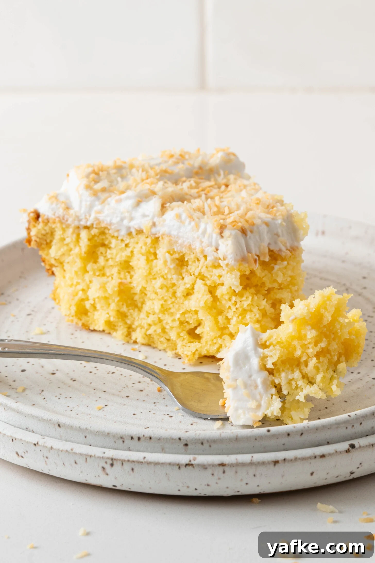 Moist Pina Colada Cake with Caramelized Pineapple 2 A pina colada cake on a plate.