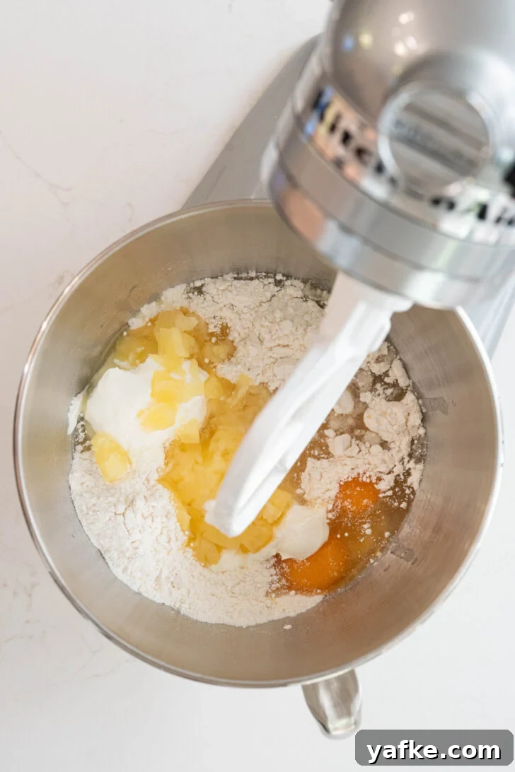 Moist Pina Colada Cake with Caramelized Pineapple 5 Cake batter with eggs, pineapple and more.