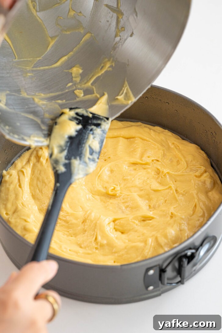 Moist Pina Colada Cake with Caramelized Pineapple 6 Cake batter pouring into a pan.