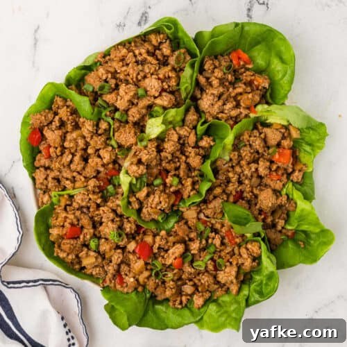 Low-Carb Chicken Recipes for Your Blackstone Griddle 17 A plate of lettuce wraps with meat and vegetables.