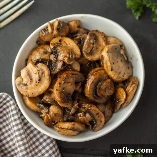 Low-Carb Chicken Recipes for Your Blackstone Griddle 22 A white bowl filled with Blackstone Sautéed Mushrooms