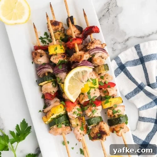 Low-Carb Chicken Recipes for Your Blackstone Griddle 4 Grilled Chicken and Vegetable kabobs stacked on a platter