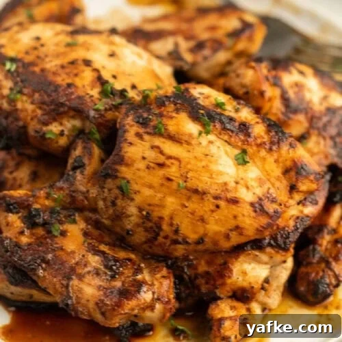 Low-Carb Chicken Recipes for Your Blackstone Griddle 6 Grilled chicken thighs on a white plate.