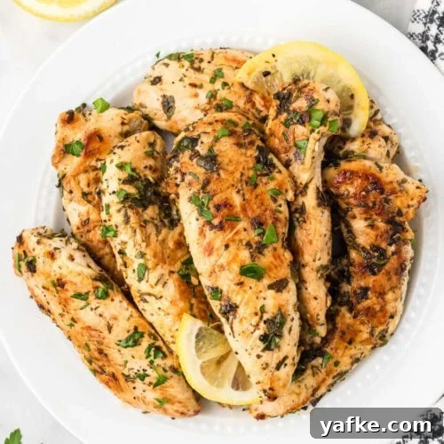 Low-Carb Chicken Recipes for Your Blackstone Griddle 8 Cooked Chicken Tenders on a plate with slice lemons
