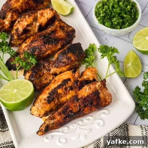 Low-Carb Chicken Recipes for Your Blackstone Griddle 9 Grilled chicken drumsticks with fresh lime and herbs on a white platter
