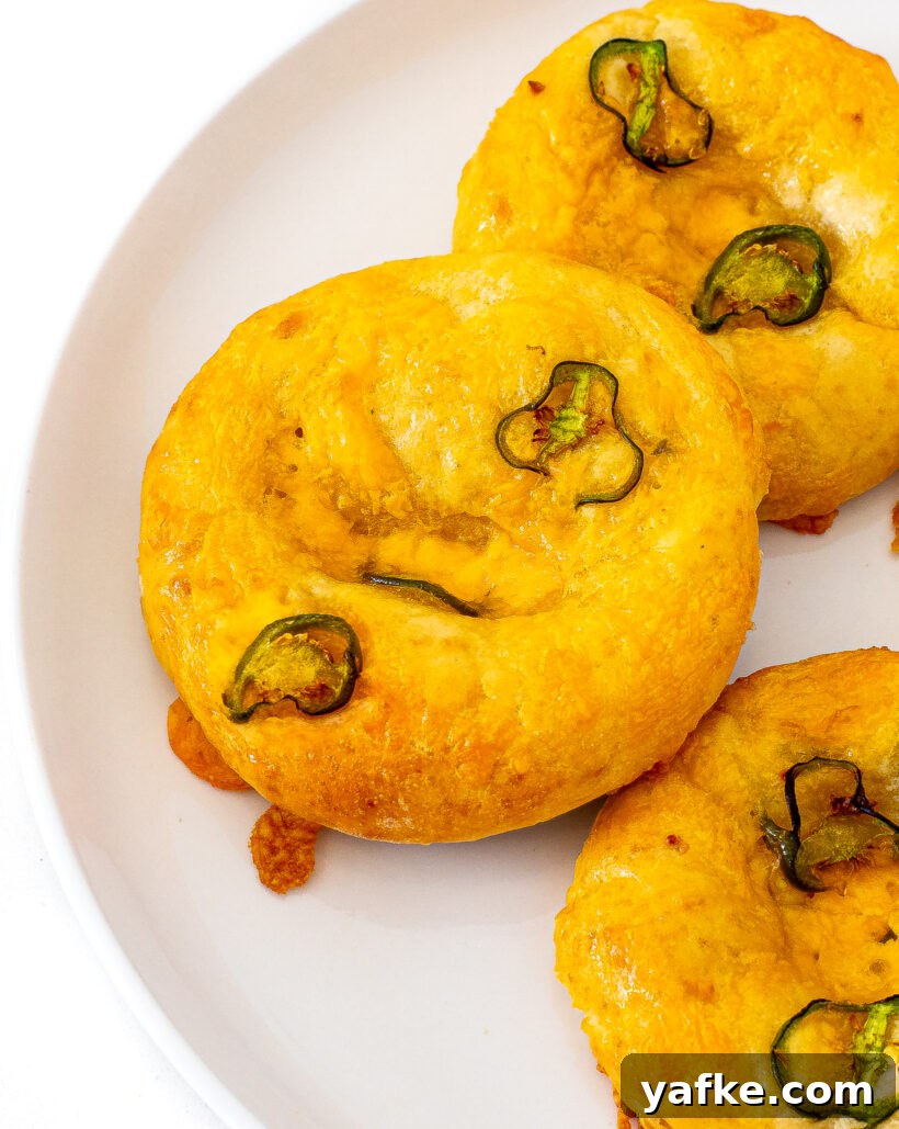 Jalapeno bagels on a white plate.