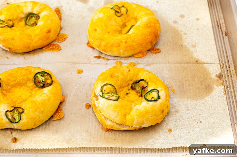 Baked jalapeno bagels on a baking sheet.
