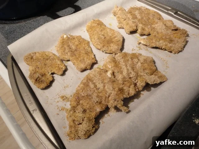 Half baked chicken cutlets with more drizzled olive oil