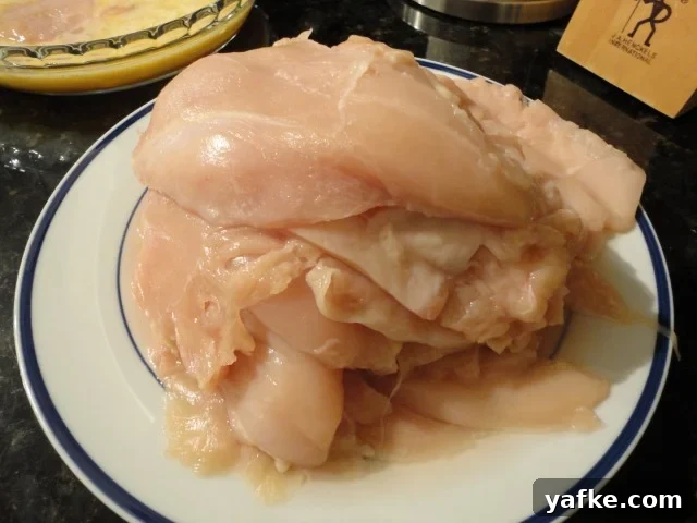 Ten pounds of chicken breasts sliced into chicken cutlets ready to be breaded
